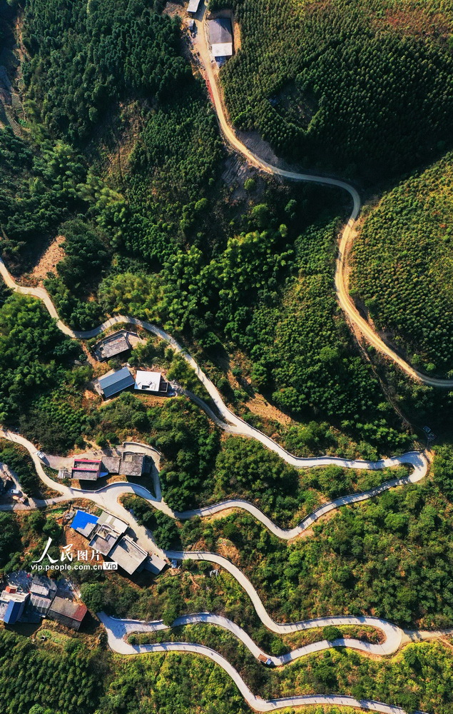 2021年2月6日，湖南省永州市宁远县中和镇西江源瑶族村，盘山公路犹如玉带环绕山间，与群山、村庄、民居相互映衬，构成一幅美丽的山村画卷。