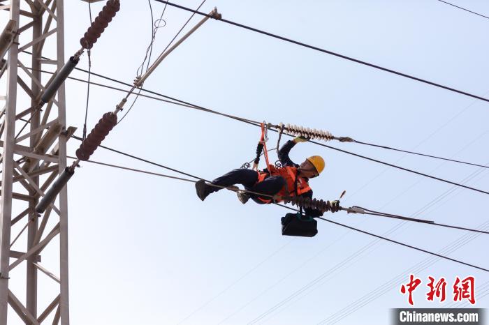 7月4日，朔黄铁路供电工队员工利用天窗时间对触网牵引锁进行调整。　孟鑫 摄