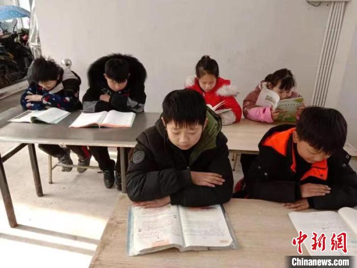 孩子们正在扶贫车间“小饭桌”上“自习课”。　刘鸿鹤 摄