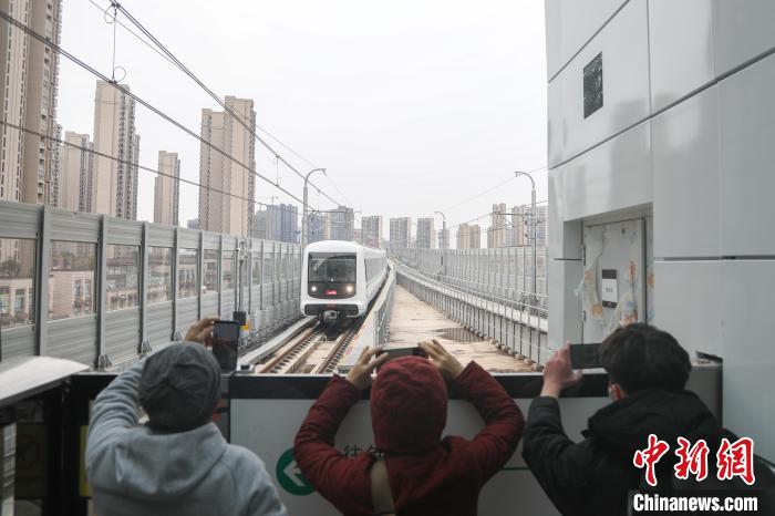 图为地铁4号线中堡站，几位民众在站台上拍摄列车进站。　刘力鑫 摄