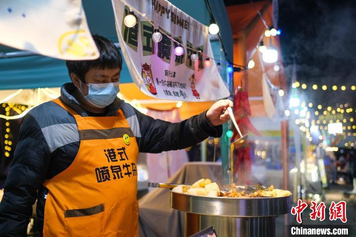 12月14日晚，南岸区南滨路的彩虹集市上，摊主正在制作美食。　何蓬磊 摄